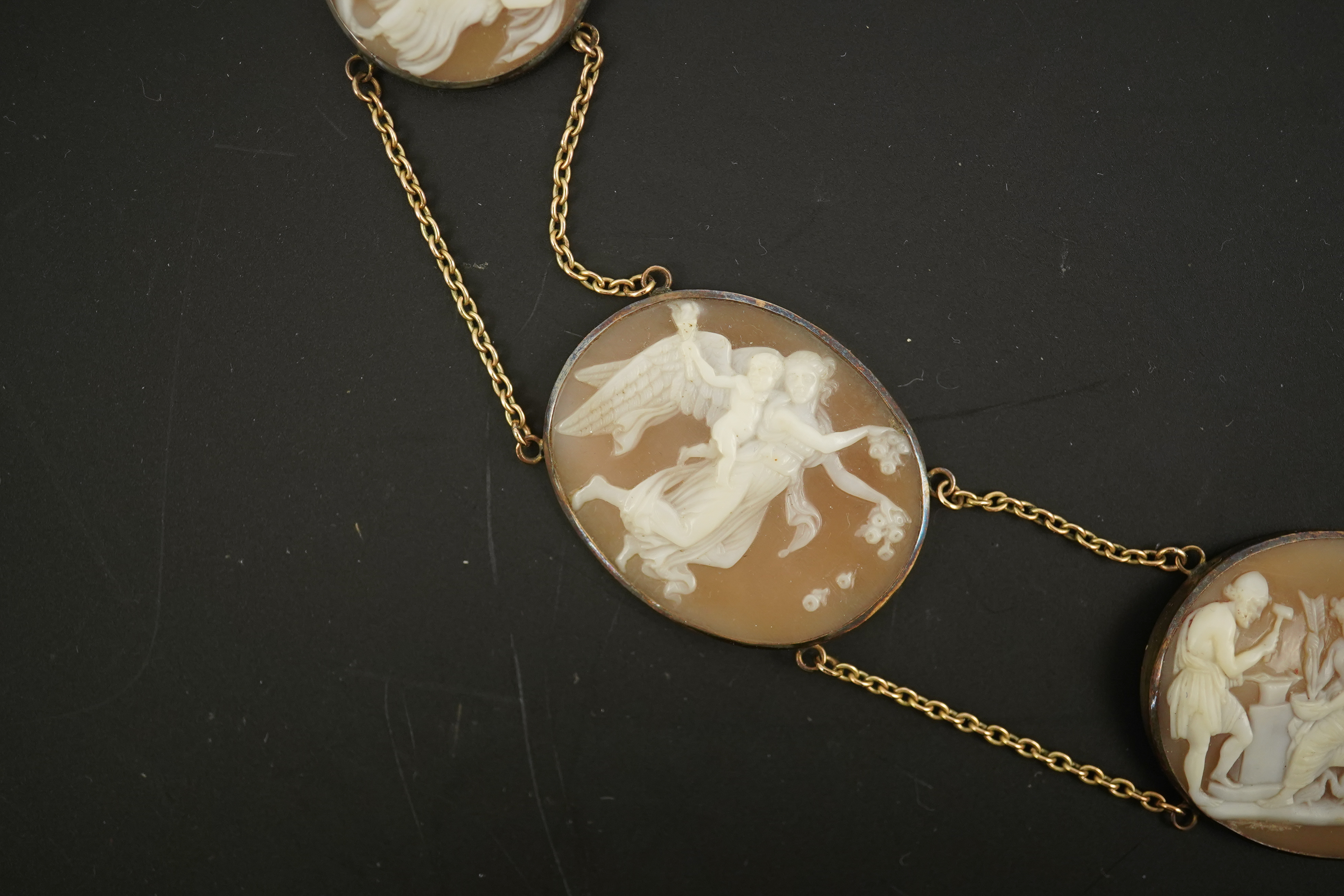 An early 19th century Italian Grand Tour gold double chain link and ten graduated oval cameo shell set necklace